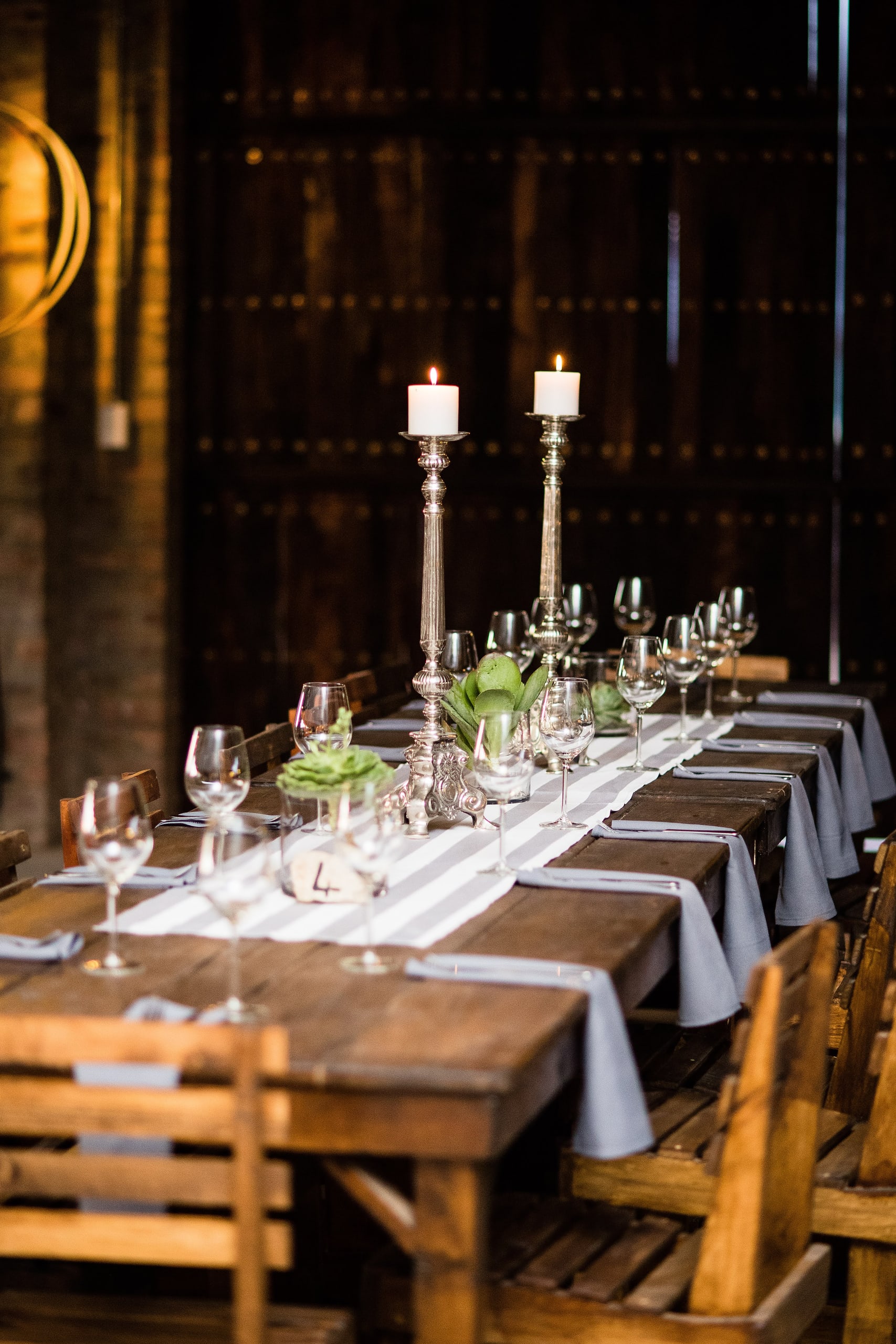 A long wooden table set for a celebration inside Kampala’s rustic venue